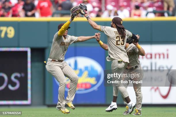 Juan Soto, Fernando Tatis Jr. #23 and Trent Grisham of the San Diego Padres celebrate their win over the Cincinnati Reds at Great American Ball Park...