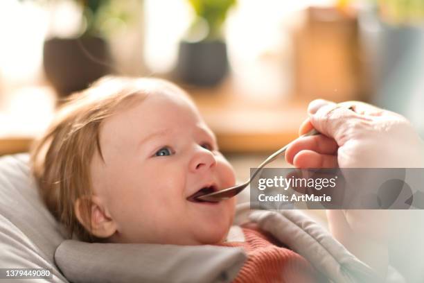 cute little girl recieving  a vitamin or medicine - vitamin d stockfoto's en -beelden