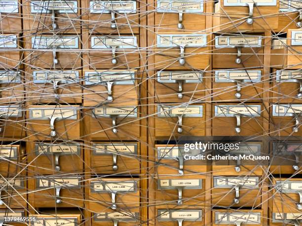 traditional wooden library card catalog cabinet covered in string - junk drawer stock pictures, royalty-free photos & images