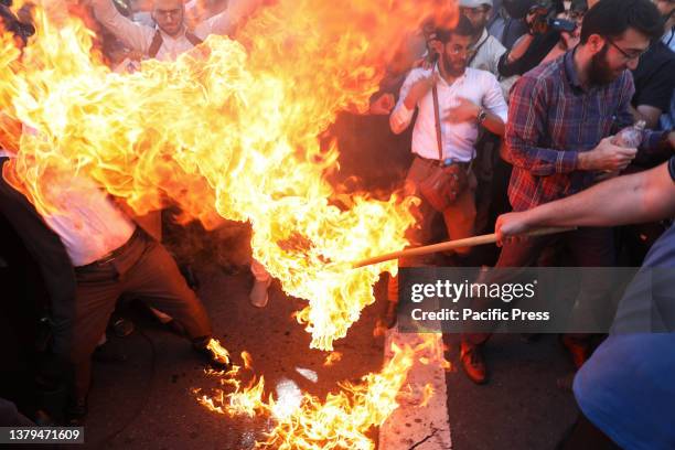 Iranian demonstrators burn a Swedish flag in front of the Swedish Embassy during a protest of the burning of a Quran in Sweden. On Wednesday, Salwan...