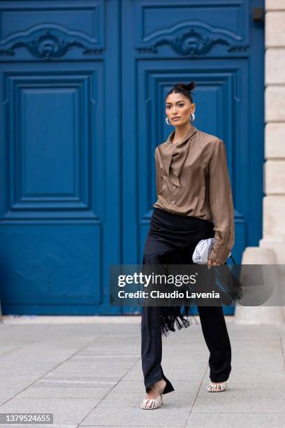 Pritika Swarup, wearing a brown blusa, white shoes and black fringes pants, is seen on the streets of Paris, during Paris Fashion Week - Womenswear...