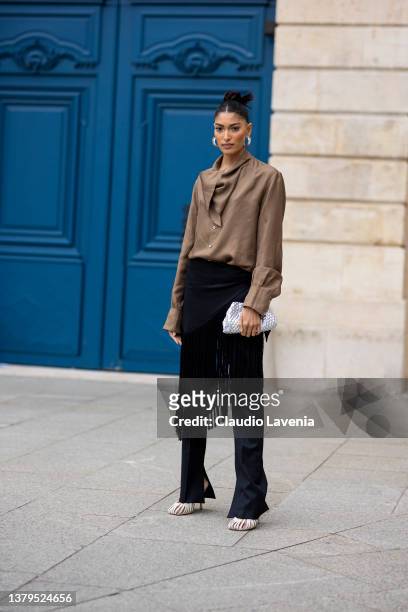 Pritika Swarup, wearing a brown blusa, white shoes and black fringes pants, is seen on the streets of Paris, during Paris Fashion Week - Womenswear...
