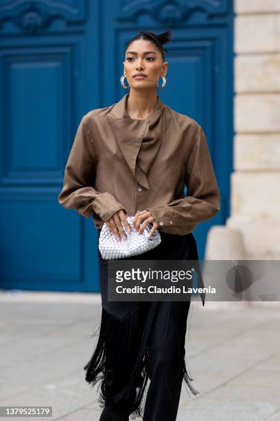 Pritika Swarup, wearing a brown blusa, white shoes and black fringes pants, is seen on the streets of Paris, during Paris Fashion Week - Womenswear...