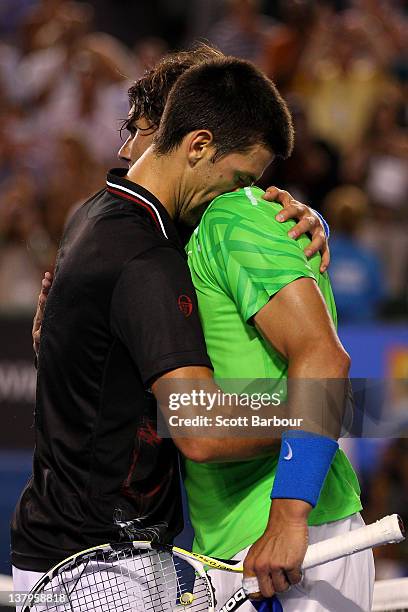 Novak Djokovic of Serbia hugs Raphael Nadal of Spain after his men's final match against Rafael Nadal of Spain during day fourteen of the 2012...