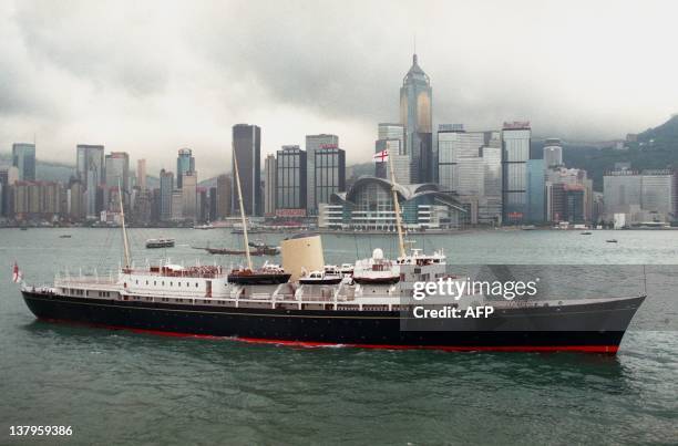 Her Majesty's Ship the royal yacht Britannia steams past the new extension of the Hong Kong Convention and Exhibition Center where the handover...