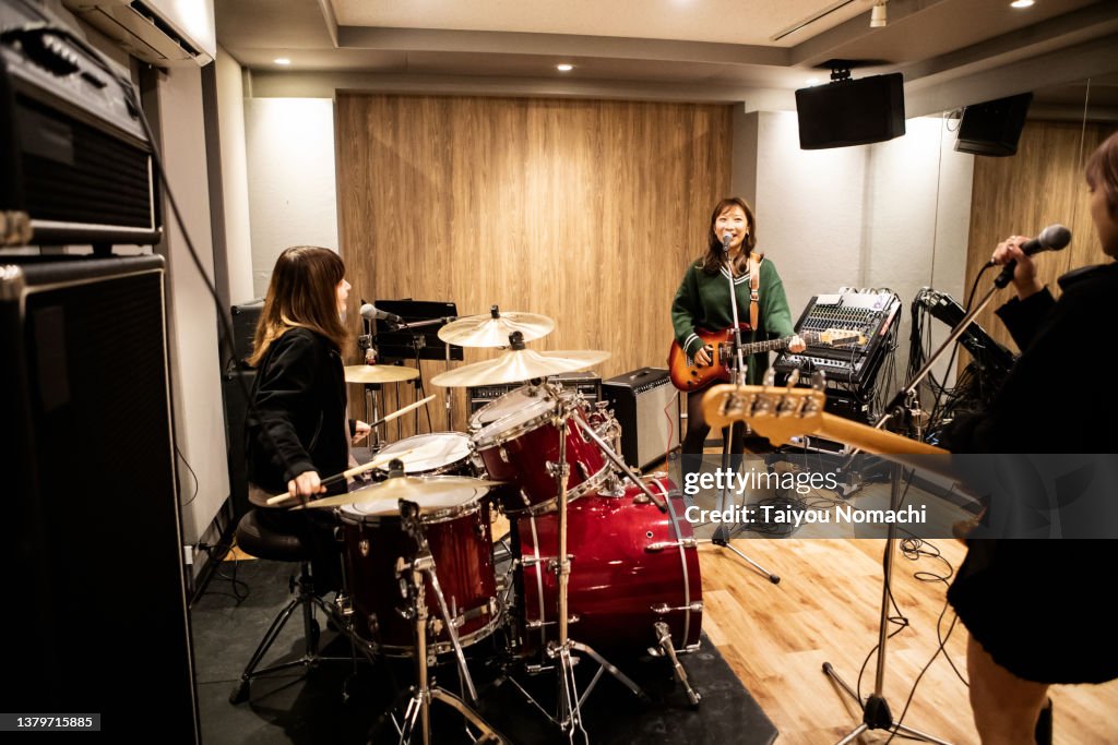 Band Session Members Of A Female Band Begin To Discuss During A Practice Session At ...