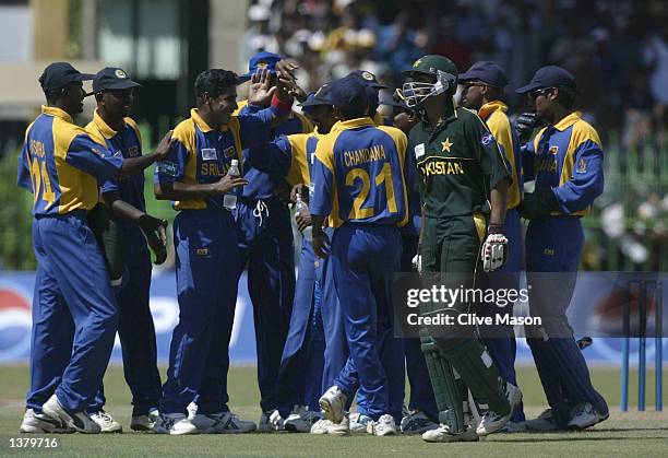 Shaoib Malik of Pakistan walks off as the Sri Lankans celebrate his dismissal after referral to the third umpire judged him to be LBW during the ICC...