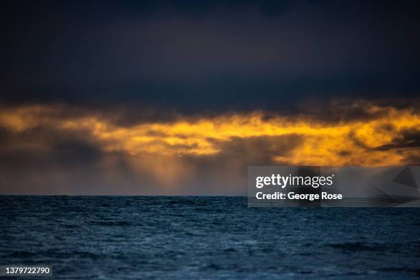 Colorful sunset is muted by gathering storm clouds as viewed along the horizon from Gaviota Beach State Park on March 3 in Gaviota, California....