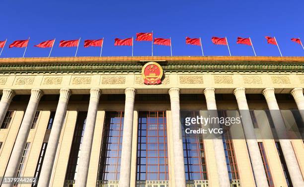 Chinese national flag flutters on the Great Hall of the People ahead of the opening meeting of the fifth session of the 13th National People's...