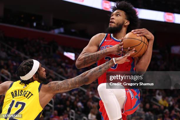 Marvin Bagley III of the Detroit Pistons tries to get a shot of next to Oshae Brissett of the Indiana Pacers during the second half at Little Caesars...