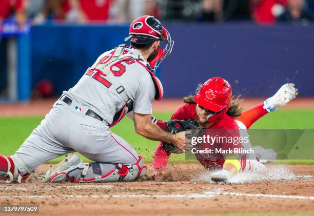 Bo Bichette of the Toronto Blue Jays is tagged out at home plate by Connor Wong of the Boston Red Sox to end the game in the ninth inning in their...