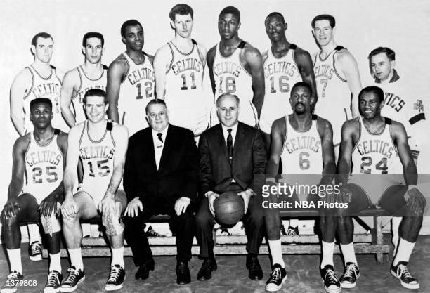 The World Champions of basketball Boston Celtics pose for a team portrait seated : K.C. Jones, Tom Heinsohn, President Louis Pieri, Head Coach Red...