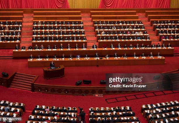 Chinese Premier Li Keqiang speaks from the podium as President Xi Jinping, centre, and members of the government look on at the opening session of...