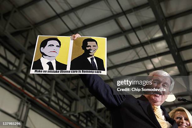 Republican presidential candidate, former Speaker of the House Newt Gingrich holds a sign made by a supporter during a campaign rally at the Tampa...