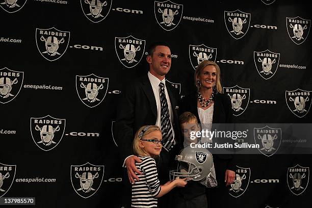 New Oakland Raiders head coach Dennis Allen poses for a photo with his wife Alisson, daughter Layla and son Garrison during a press conference on...