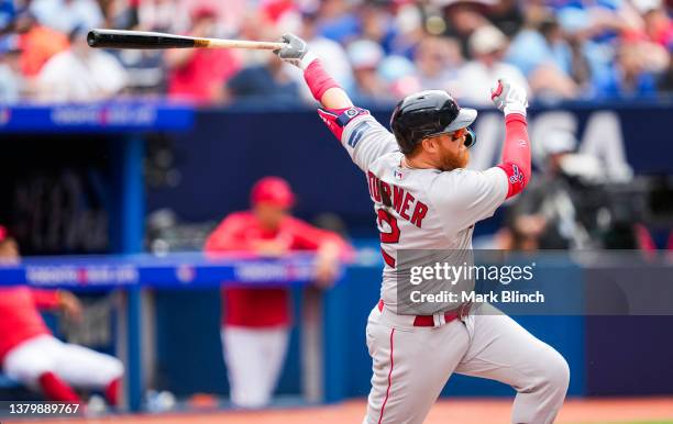 Justin Turner of the Boston Red Sox hits an RBI double against the Toronto Blue Jays during the fifth inning in their MLB game at the Rogers Centre...