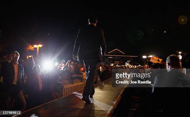 Republican presidential candidate, former Massachusetts Gov. Mitt Romney walks onto the stage as he is introduced during a grassroots rally with...