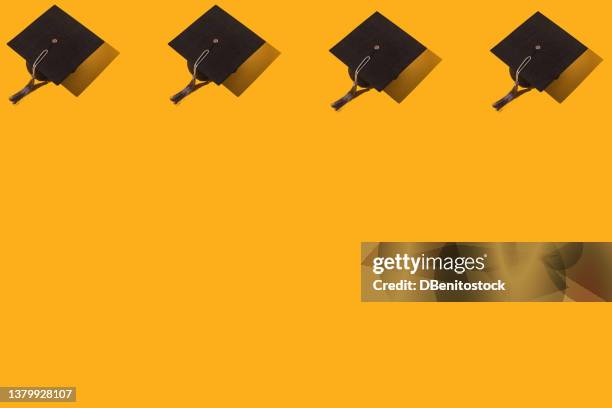 pattern of black graduation caps with gray tassel with hard shadow, on top, on yellow background. graduation, achievement, goal, degree, master, bachelor, university, college and success concept. - higher school certificate stock-fotos und bilder