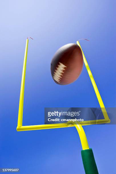 ball kicked during field goal in game of american football - football goal post stock pictures, royalty-free photos & images