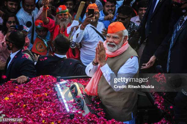 Varanasi, INDIA India's Prime Minister Narendra Modi greets crowds of supporters during a roadshow in support of state elections on March 04, 2022 in...