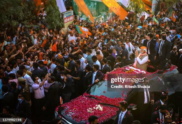 Varanasi, INDIA India's Prime Minister Narendra Modi greets crowds of supporters during a roadshow in support of state elections on March 04, 2022 in...