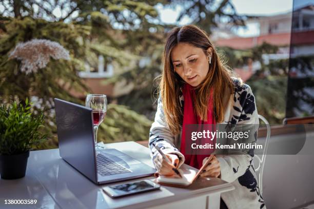 beautiful businesswoman having video conference at cafe - cfo stock pictures, royalty-free photos & images