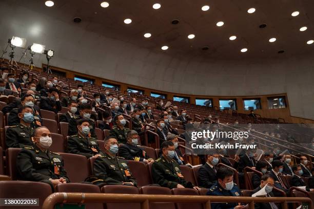 Attendees, many from the Chinese military, listen in the gallery at the opening session of the National Peoples Congress at the Great Hall of the...