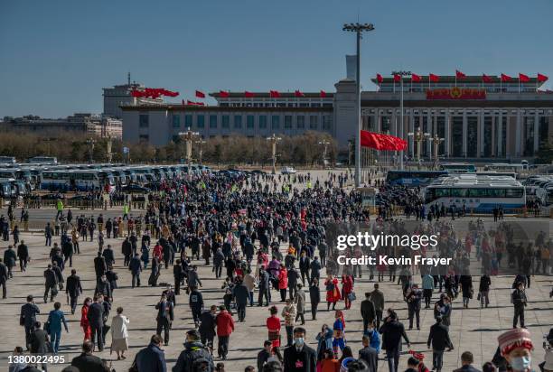 Delegates, officials, media and others leave the opening session of the National Peoples Congress at the Great Hall of the People on March 5, 2022 in...