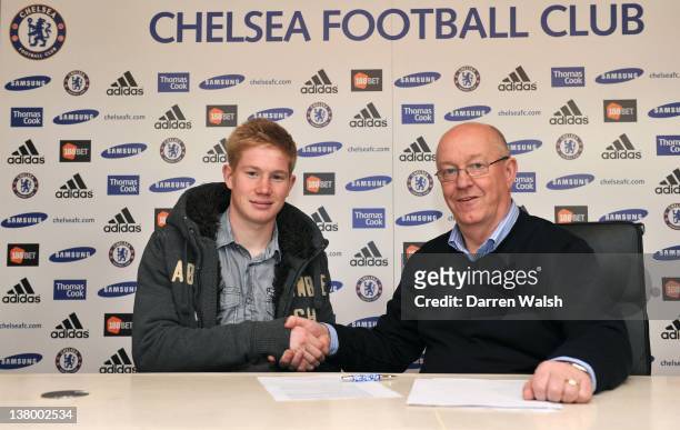 Kevin De Bruyne signs for Chelsea FC alongside Chelsea club Secretary/Director David Barnard at the Cobham Training ground on January 31, 2012 in...