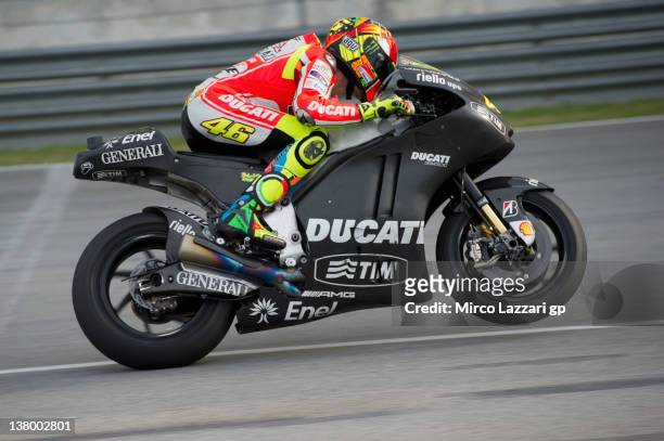 Valentino Rossi of Italy and and Ducati Marlboro Team lifts the front wheel during the first day of MotoGP testing at Sepang Circuit on January 31,...