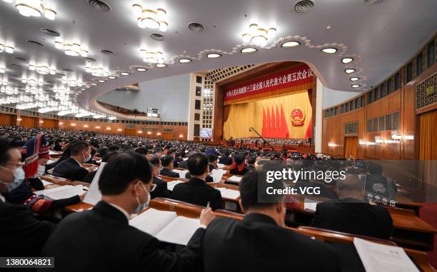 Deputies attend the opening meeting of the fifth session of the 13th National People's Congress at the Great Hall of the People on March 5, 2022 in...