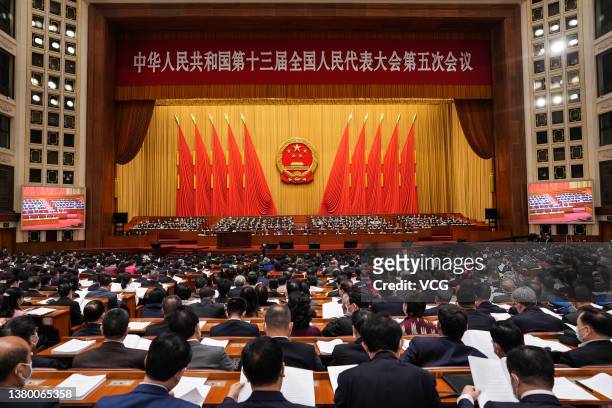 Deputies attend the opening meeting of the fifth session of the 13th National People's Congress at the Great Hall of the People on March 5, 2022 in...