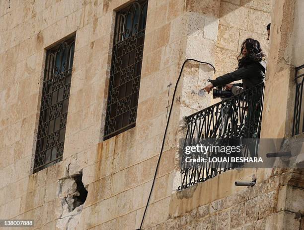 Journalists take part in a guided government tour of the Sednaya Monastery to view damage caused to the convent during a recent shelling on January...