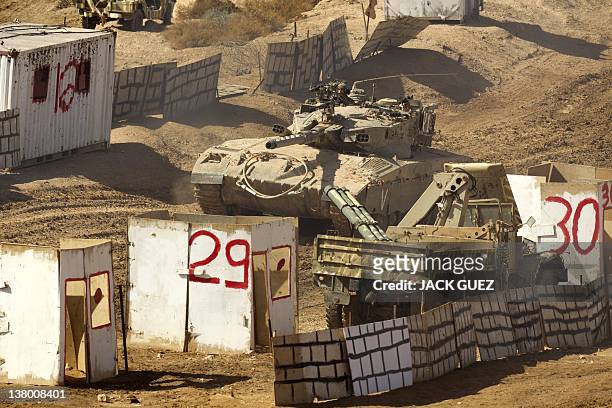 An Israeli Merkava tank takes position in a mock city during an exercise at the Shizafon army base, in the Negev Desert north of the southern city of...