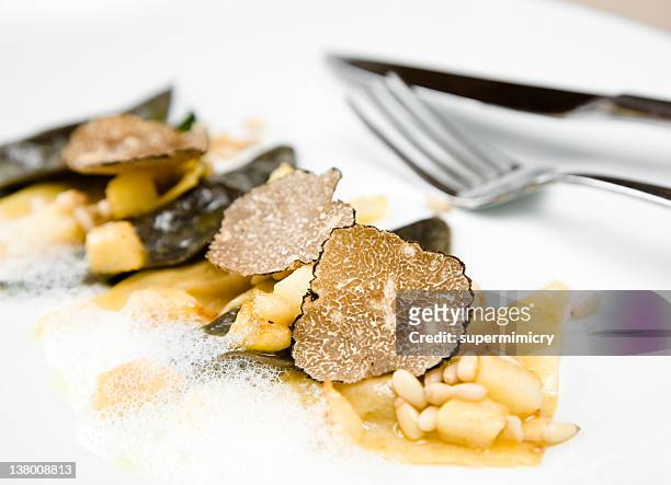 black truffle ravioli with a fork - savory sauce stock pictures, royalty-free photos & images