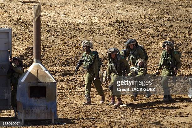 Israeli soldiers evacuate a soldier during an exercise at the Shizafon army base, in the Negev Desert north of the southern city of Eilat, on January...