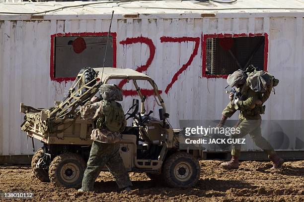 An Israeli soldier evacuates a comrade during an exercise at the Shizafon army base, in the Negev Desert north of the southern city of Eilat, on...