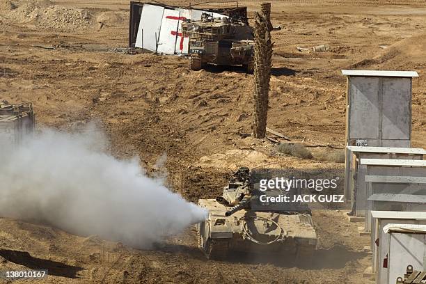 An Israeli Merkava tank takes position in a mock city during an exercise at the Shizafon army base, in the Negev Desert north of the southern city of...