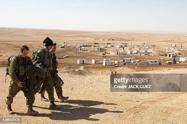 Israeli army soldiers leave the battlefield after an exercise at the Shizafon army base, in the Negev Desert north of the southern city of Eilat, on...