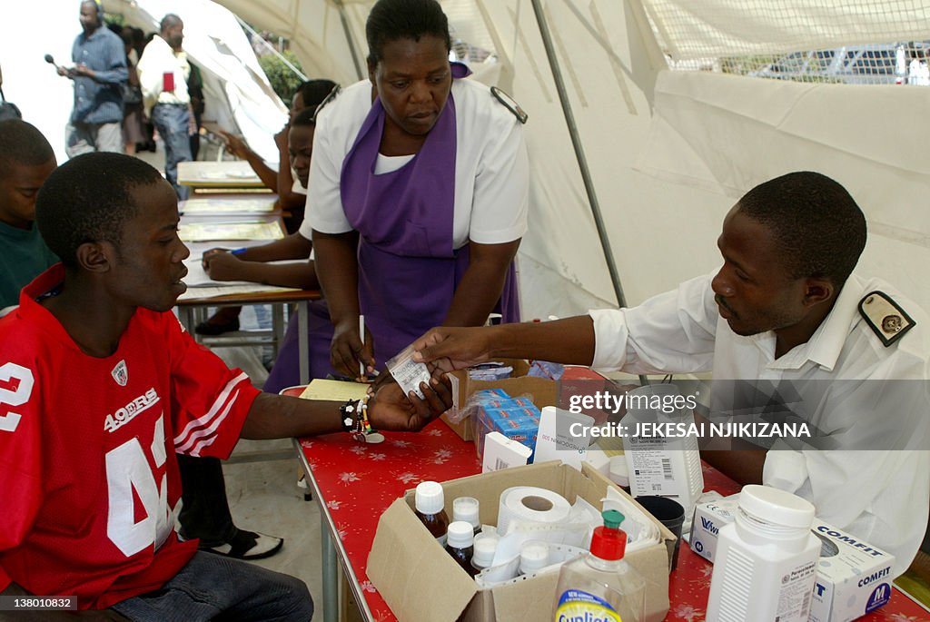 Patients receive medication at a typhoid