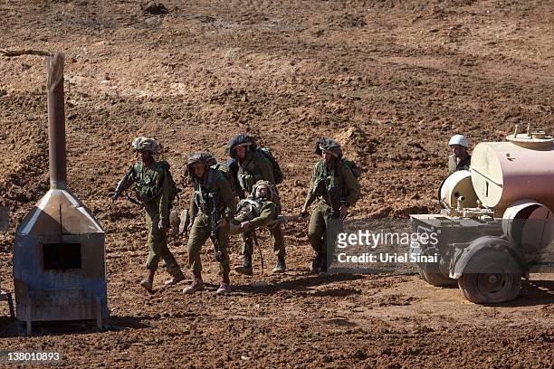Israeli soldiers evacuate a soldier during an army exercise on at the Shizafon army base, in the Negev Desert north of the southern city of Eilat on...