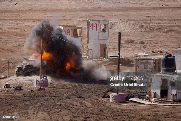 Ball of fire rises after an Israeli Merkava tank shot a shell at a truck during an army exercise on at the Shizafon army base, in the Negev Desert...