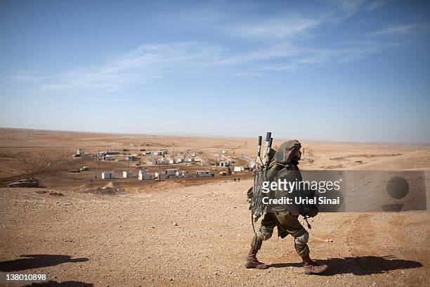 An Israeli soldier leaves the battlefield after an army exercise on at the Shizafon army base, in the Negev Desert north of the southern city of...