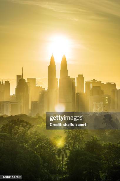 majestic sunrise over downtown kuala lumpur with petronas twin towers  still among the significant landmarks and icon for malaysia. - kuala lumpur twin tower stock pictures, royalty-free photos & images