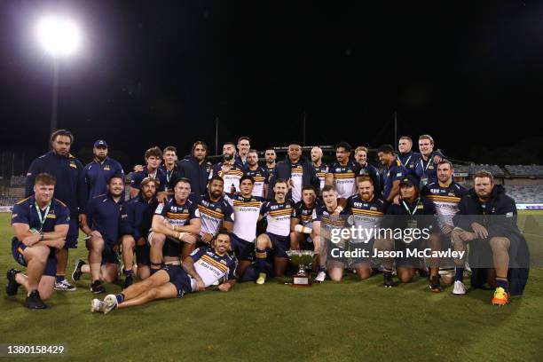 Brumbies players pose with the Dan Vickerman Cup during the round three Super Rugby Pacific match between the ACT Brumbies and the NSW Waratahs at...