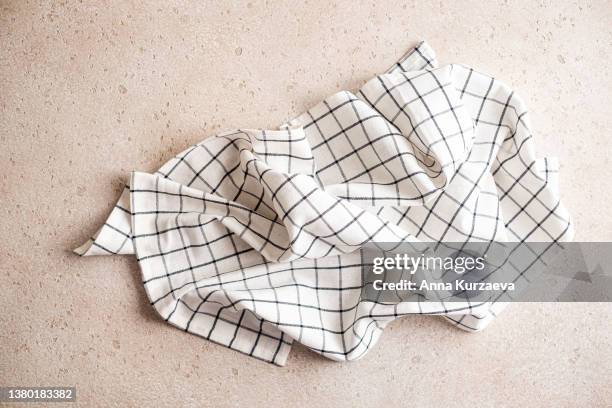 white and black linen checkered napkin folded on concrete background, top view - serviette freisteller stock-fotos und bilder