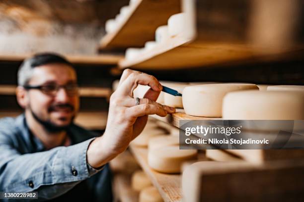 the cheese maker marks the cheese - dairy factory stock pictures, royalty-free photos & images