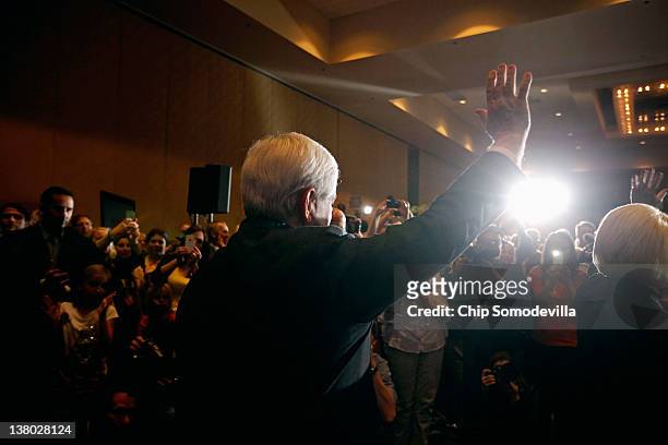 Republican presidential candidate, former Speaker of the House Newt Gingrich waves as he arrives for his Florida primary night party January 31, 2012...
