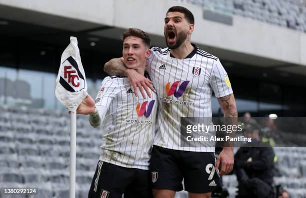 Harry Wilson of Fulham celebrates with teammate Aleksandar Mitrovic after scoring their side's second goal during the Sky Bet Championship match...