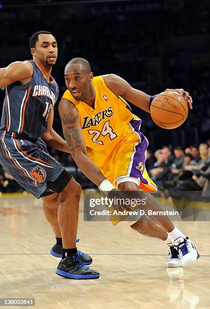 Kobe Bryant of the Los Angeles Lakers drives to the basket against Gerald Henderson of the Charlotte Bobcats at Staples Center on January 31, 2012 in...